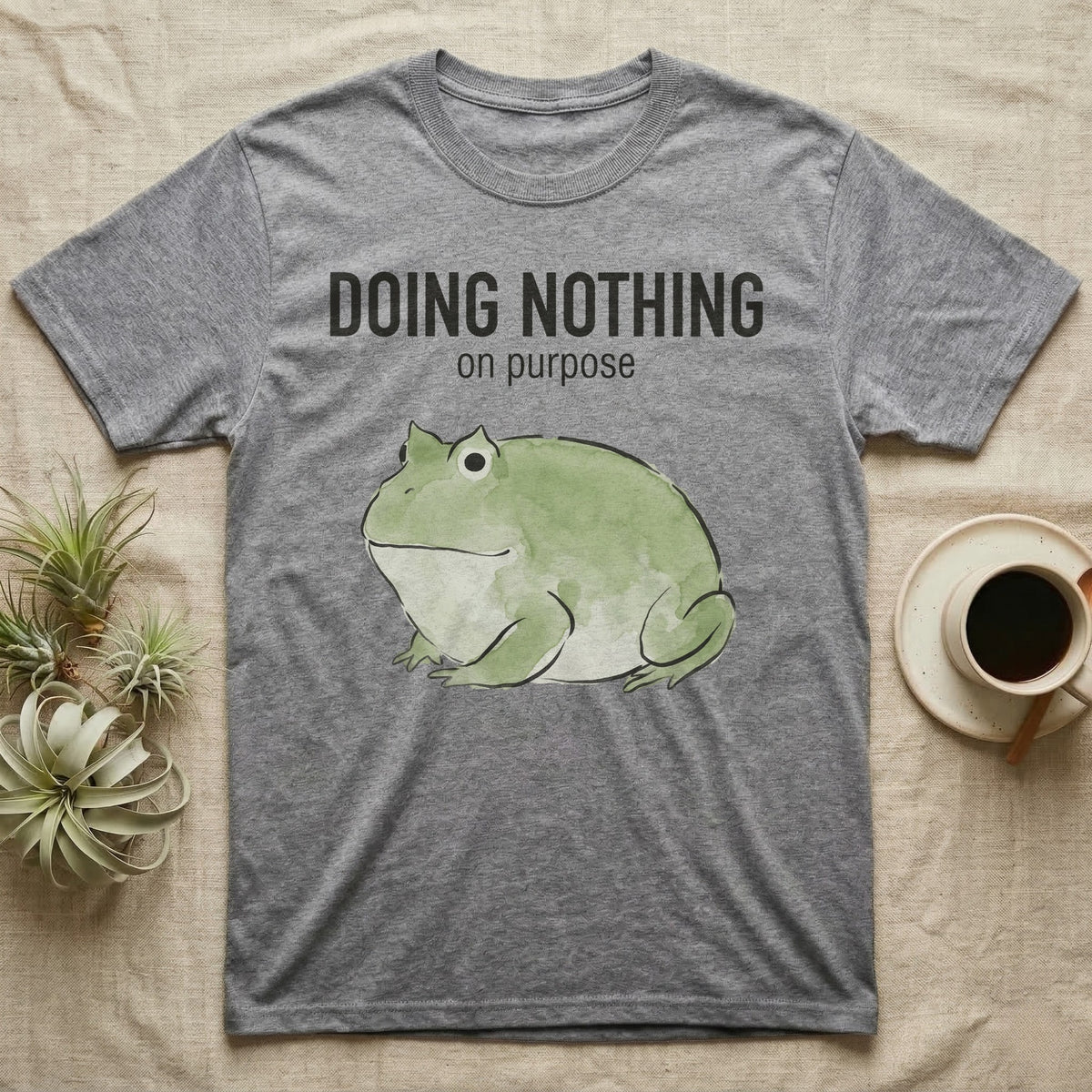 Pacman Frog Doing Nothing T-Shirt in Sport Grey — Watercolour pacman frog blob in profile below the words doing nothing on purpose, on grey