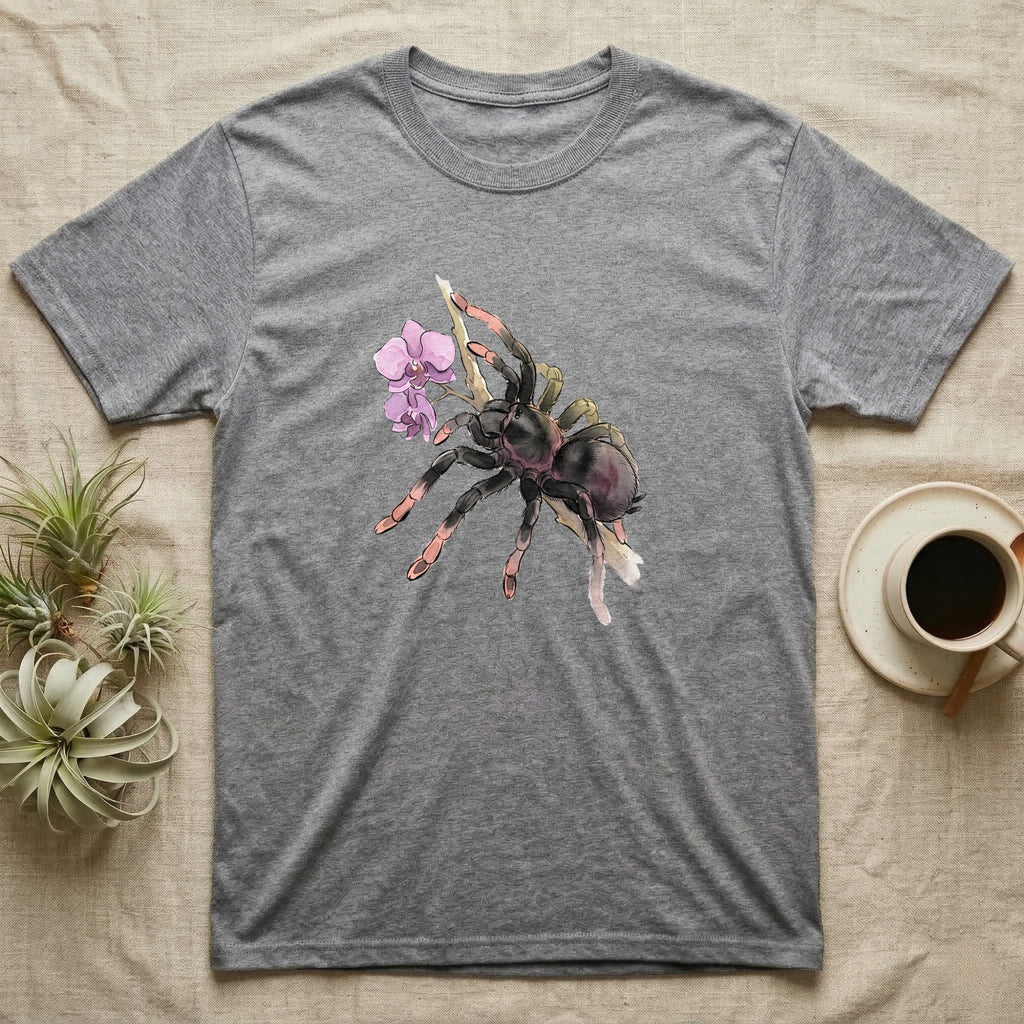 Pink-Toe Tarantula Blossom T-Shirt in Sport Grey — Watercolor illustration of a charcoal pink-toe tarantula with salmon toe tips holding an orchid blossom sprig, on a dark grey t-shirt.