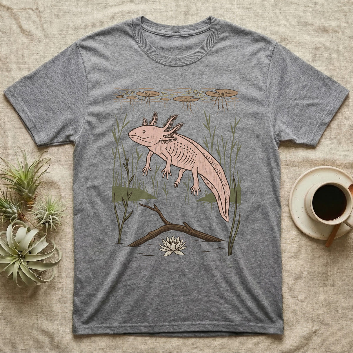 Axolotl Home Range T-Shirt in Sport Grey — Woodcut-style illustration of an axolotl drifting among reeds and lily pads in a Xochimilco canal, no on-shirt text.