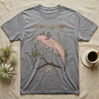 Axolotl Home Range T-Shirt in Sport Grey — Woodcut-style illustration of an axolotl drifting among reeds and lily pads in a Xochimilco canal, no on-shirt text.