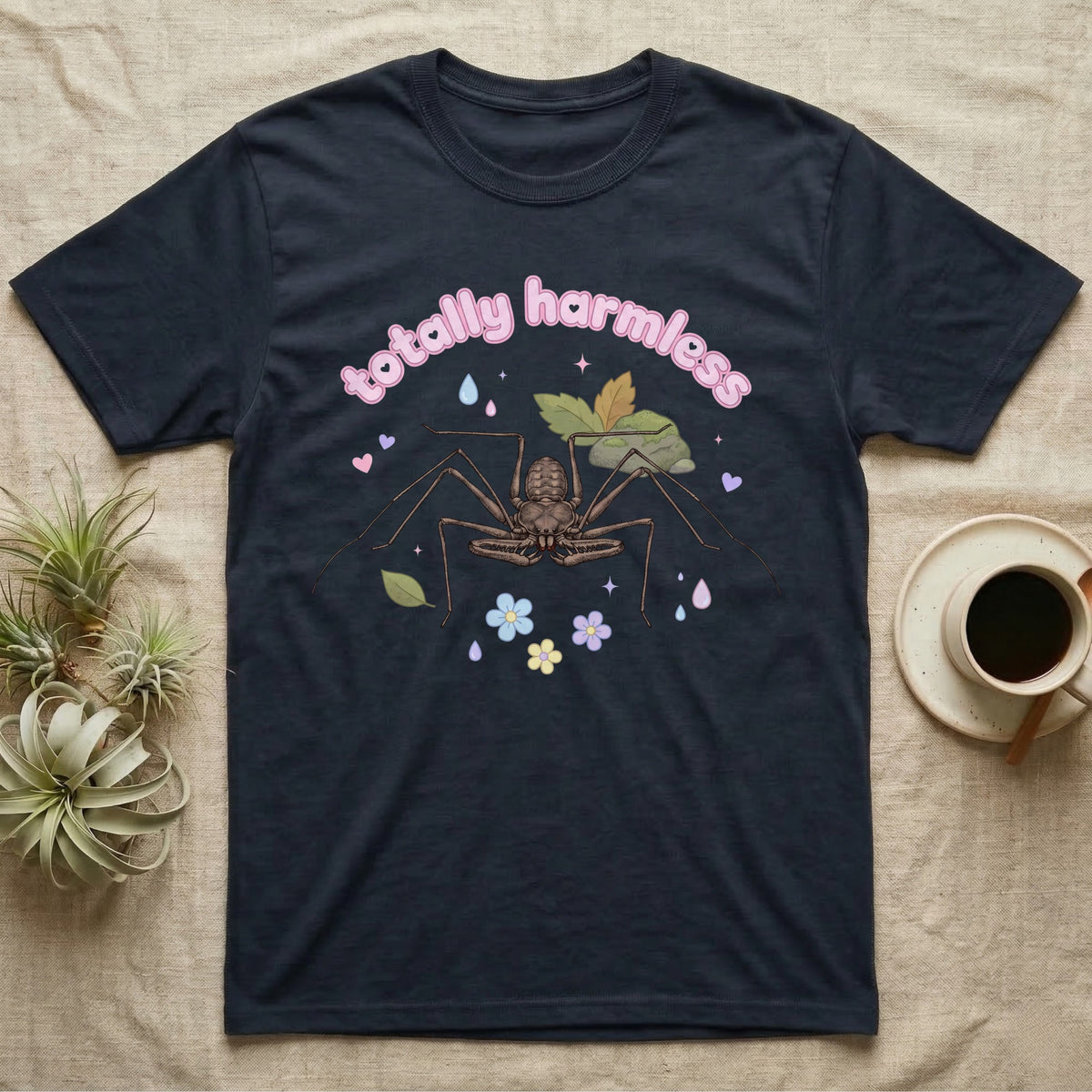 Tailless Whip Scorpion Baby T-Shirt in Navy — Pastel tailless whip scorpion with long whip legs among leaves and blossoms, puffy pink wordmark "totally harmless" above.