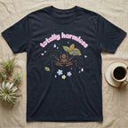 Tailless Whip Scorpion Baby T-Shirt in Navy — Pastel tailless whip scorpion with long whip legs among leaves and blossoms, puffy pink wordmark "totally harmless" above.