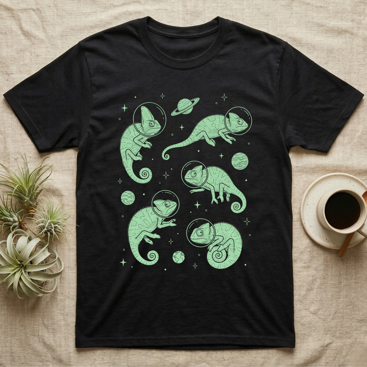 Veiled Chameleon Cosmic T-Shirt in Black — Vintage screen-print illustration of veiled chameleons in astronaut helmets floating in space, cosmic nebula mint green monochromatic on dark background.
