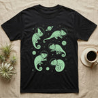 Veiled Chameleon Cosmic T-Shirt in Black — Vintage screen-print illustration of veiled chameleons in astronaut helmets floating in space, cosmic nebula mint green monochromatic on dark background.