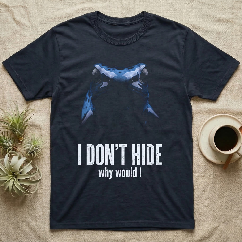 Deadpan macro mugshot of a cobalt-blue poison dart frog on black, captioned I don't hide, why would I. — shown on a Navy tee.