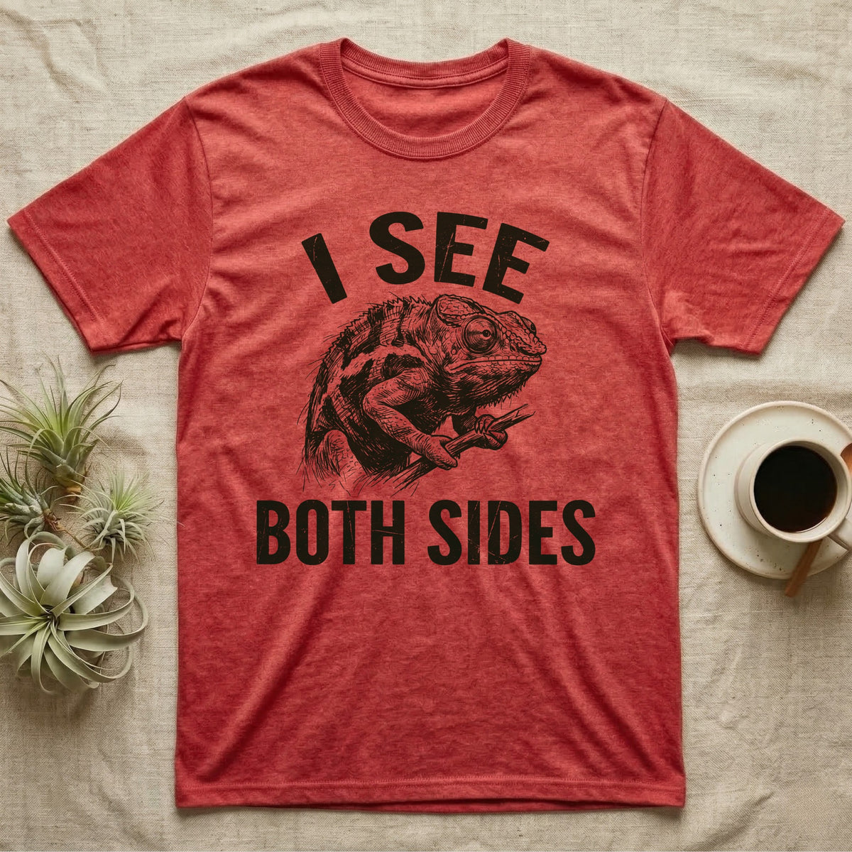 Panther Chameleon Mediator T-Shirt in Heather Red — Etching of a panther chameleon holding a twig, its eyes pointing opposite ways, under I SEE, above BOTH SIDES