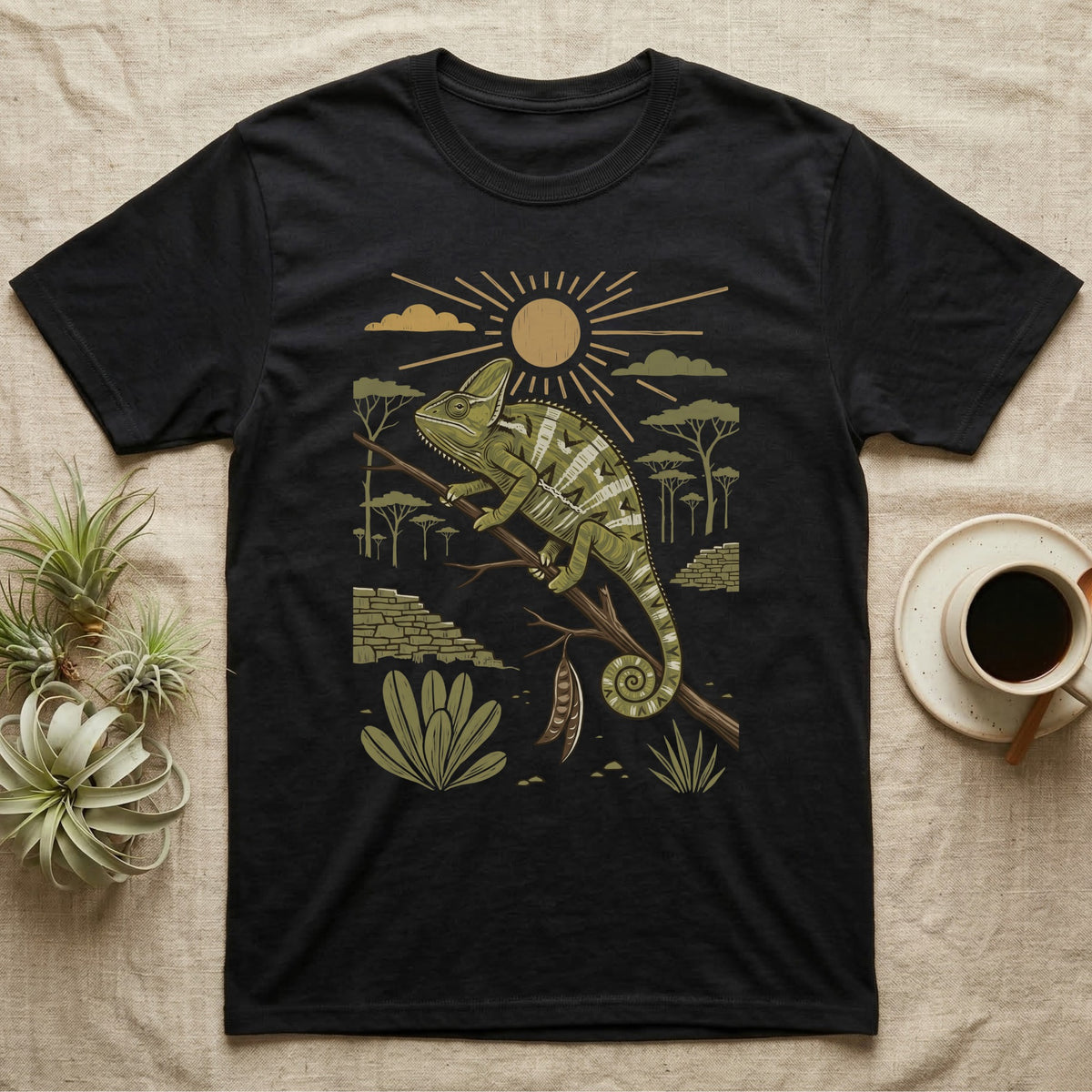 Veiled Chameleon Home Range T-Shirt in Black — Woodcut-style illustration of a veiled chameleon gripping an acacia branch with terraced walls and umbrella trees behind, no on-shirt text.