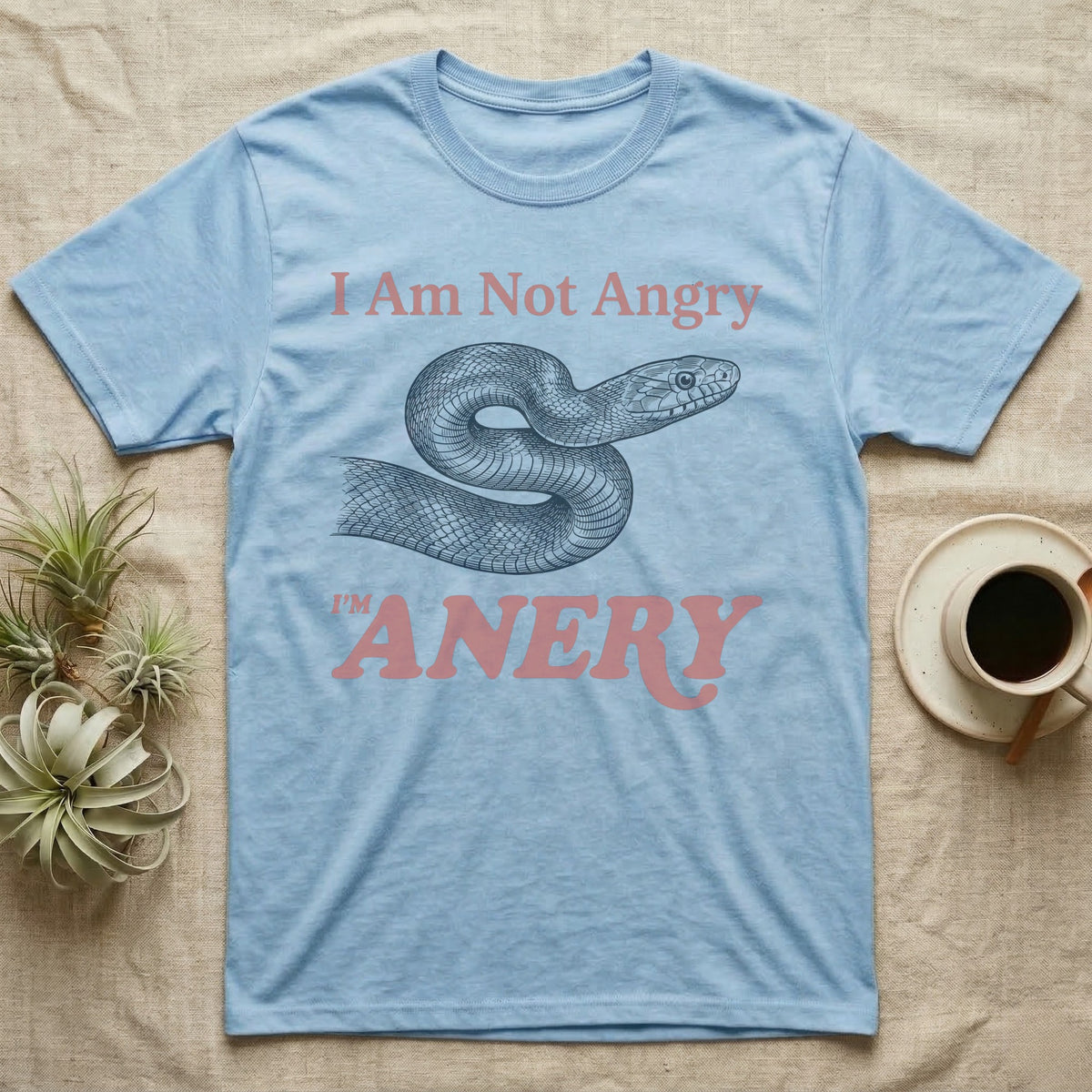 Anery Corn Snake T-Shirt in Light Blue — Engraved corn snake curled into an S between the words I Am Not Angry and I'm ANERY in dusty rose type.