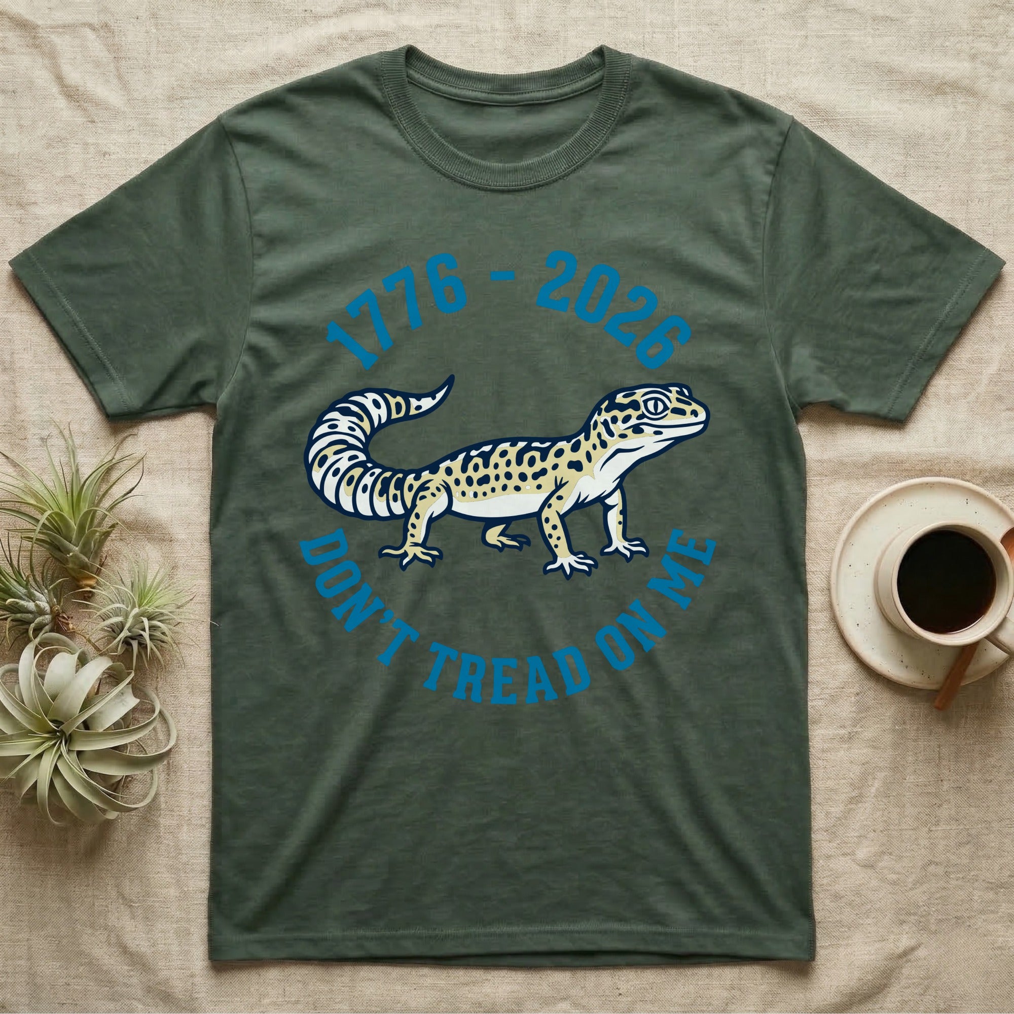 Leopard Gecko 1776 T-Shirt in Military Green — Two-colour vector leopard gecko in profile ringed by arched text reading 1776 to 2026 and Don't Tread On Me.