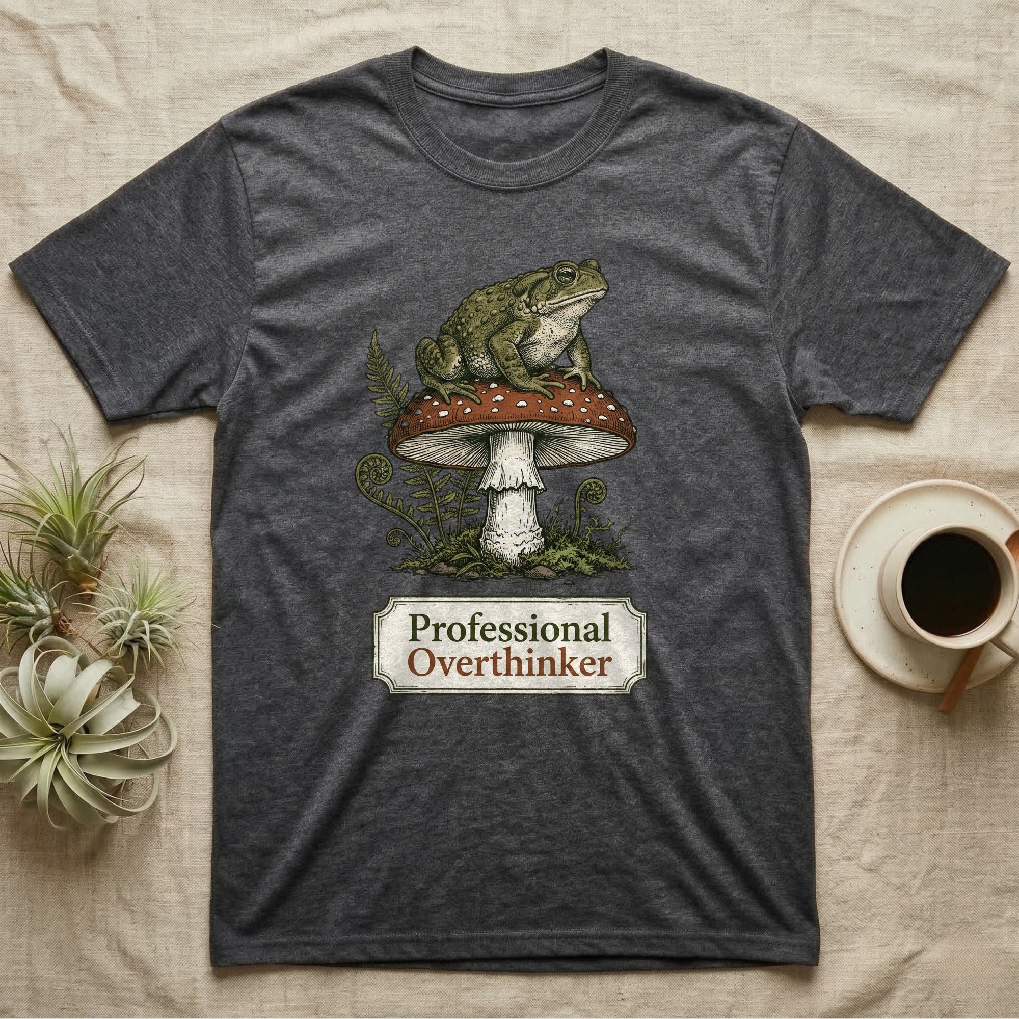 Dark gray t-shirt with a toad on a mushroom, text reads "Professional Overthinker."