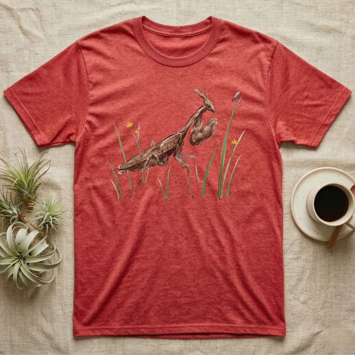 Ghost Mantis Watercolour T-Shirt in Heather Red — Watercolour ghost mantis standing still in profile with forelegs folded, watching a single fruit fly perched on a grass tip.