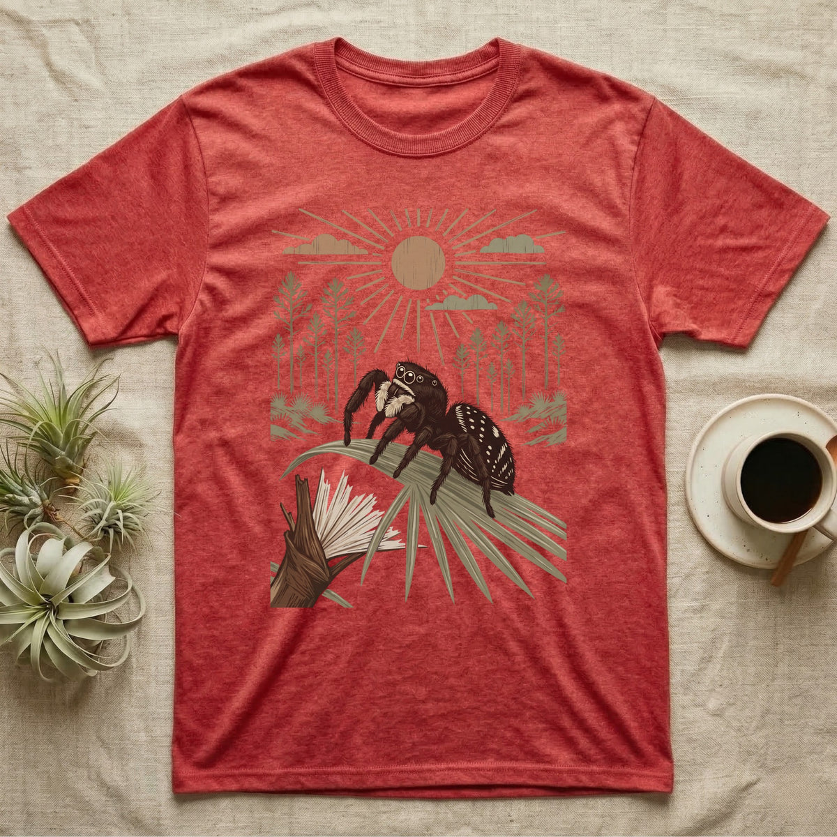 Jumping Spider Home Range T-Shirt in Heather Red — Woodcut-style illustration of a regal jumping spider perched on a saw palmetto blade with pines behind, no on-shirt text.