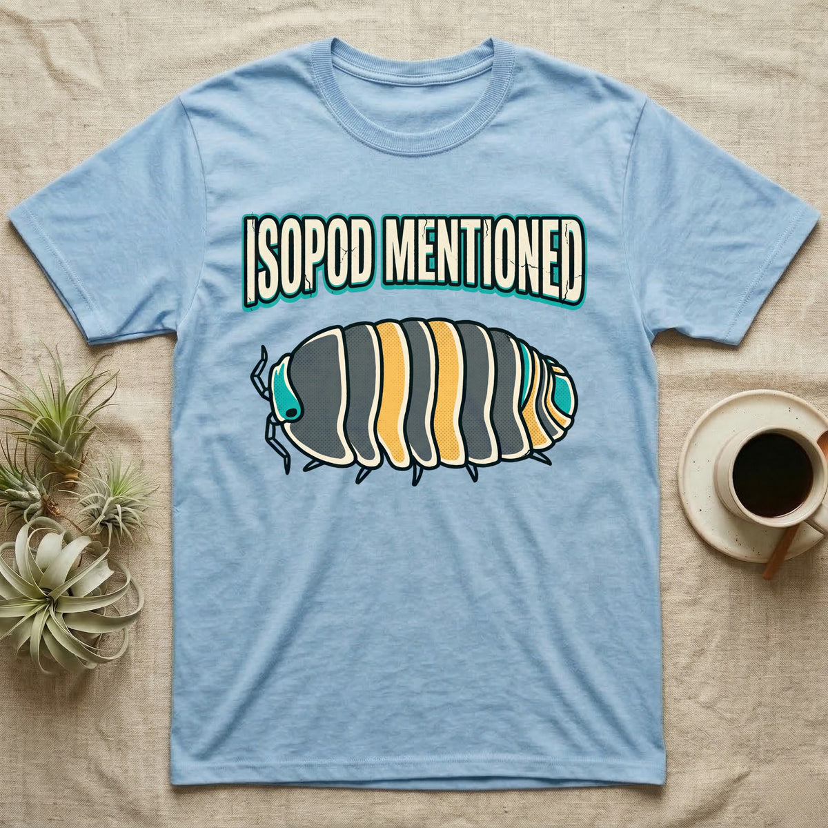 Isopod Mentioned T-Shirt in Light Blue — Bold-vector illustration of a rubber-ducky Cubaris isopod hero under big block caps reading Isopod Mentioned.