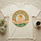 Cream t-shirt with "High Desert Sun Club" logo featuring a bearded dragon.