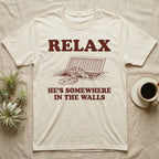 Corn Snake Walls T-Shirt in Natural — Engraved corn snake looking out of an open floor vent, with the words Relax, He's Somewhere in the Walls