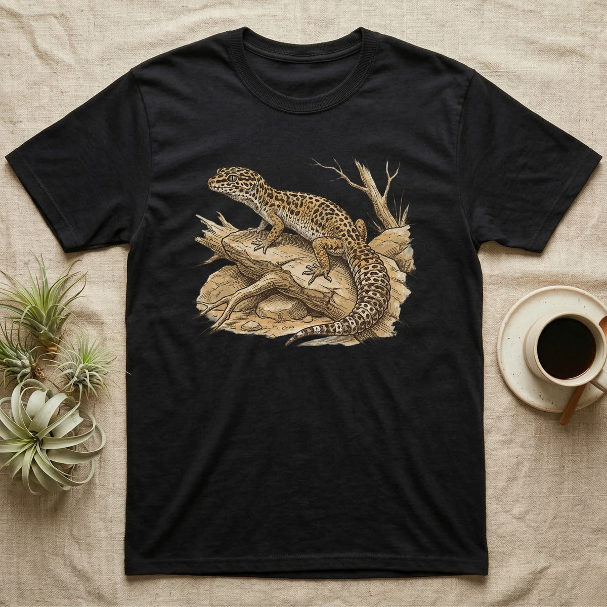 Black t-shirt featuring a detailed illustration of a leopard gecko on a rocky perch.