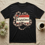 Grilled Cheese Corn Snake T-Shirt in Black — Flat retro illustration of a corn snake coiled through a "Hello my name is Mr. Grilled Cheese" name-tag badge.