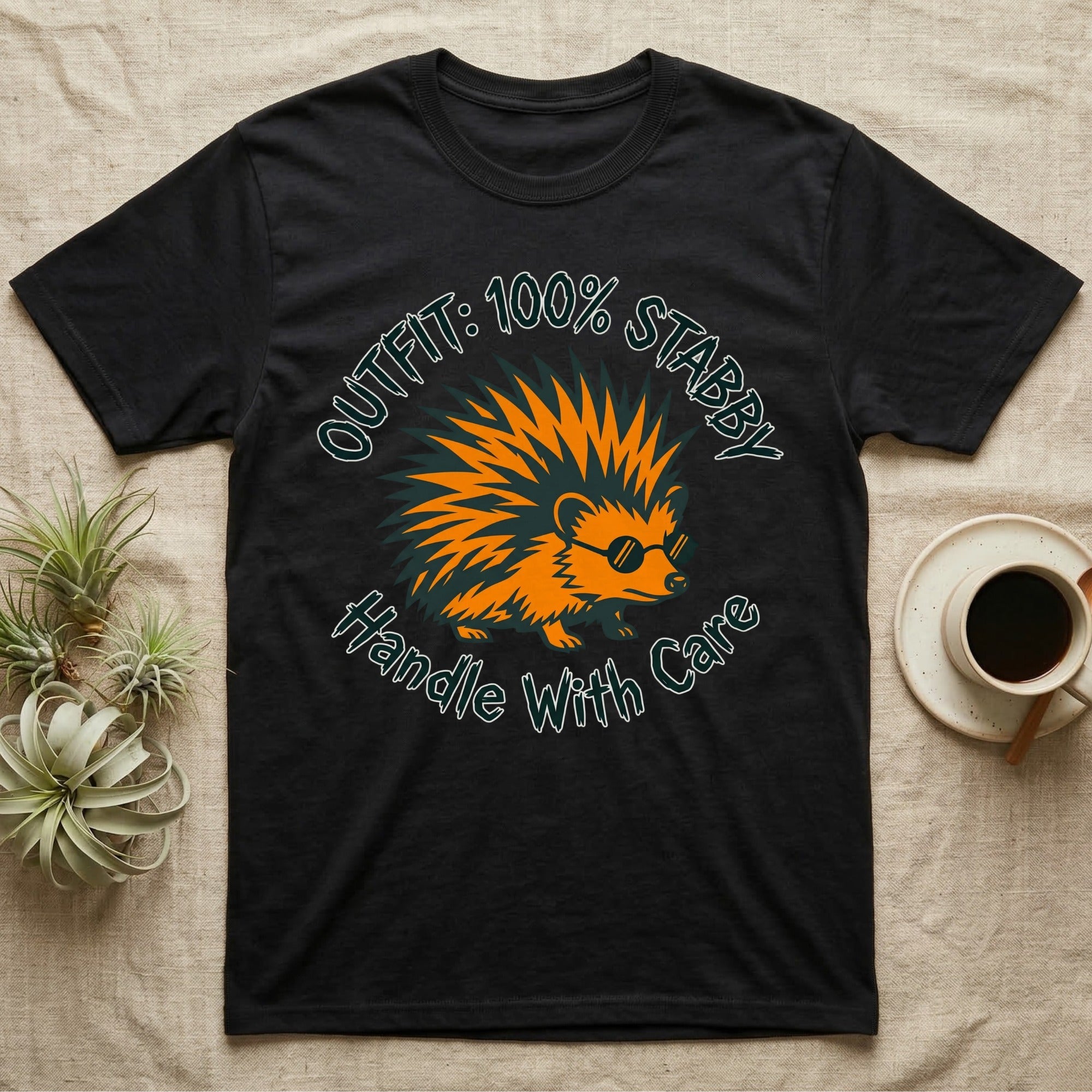 Black t-shirt with a spiky hedgehog wearing sunglasses and text "Outfit: 100% Stabby. Handle With Care."