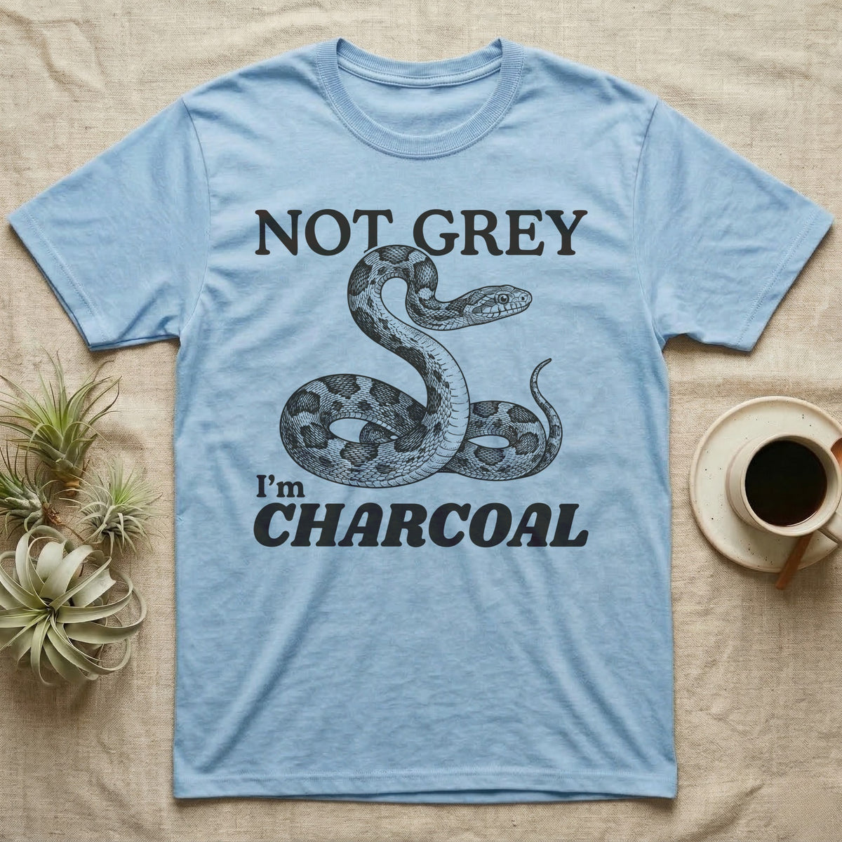 Charcoal Corn Snake T-Shirt in Light Blue — Engraved grey corn snake reared back in an S-curve under dark lettering reading NOT GREY, I'm CHARCOAL