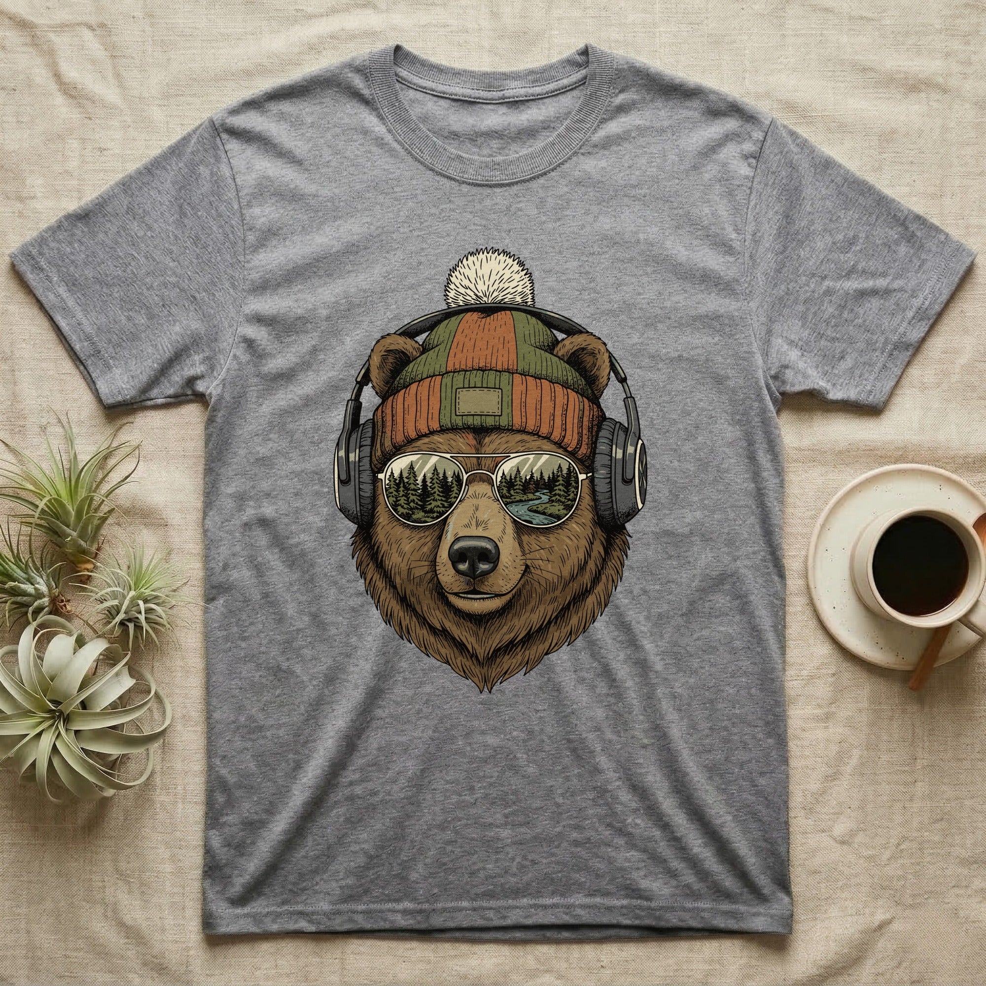 T-shirt featuring a bear wearing headphones and a beanie, with a forest scene in sunglasses.