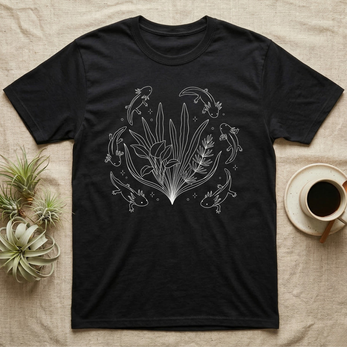 Axolotl Fine Line Botanical T-Shirt in Black — Fine-line white ink illustration of five axolotls drifting around a fanned spray of anubias and java fern.