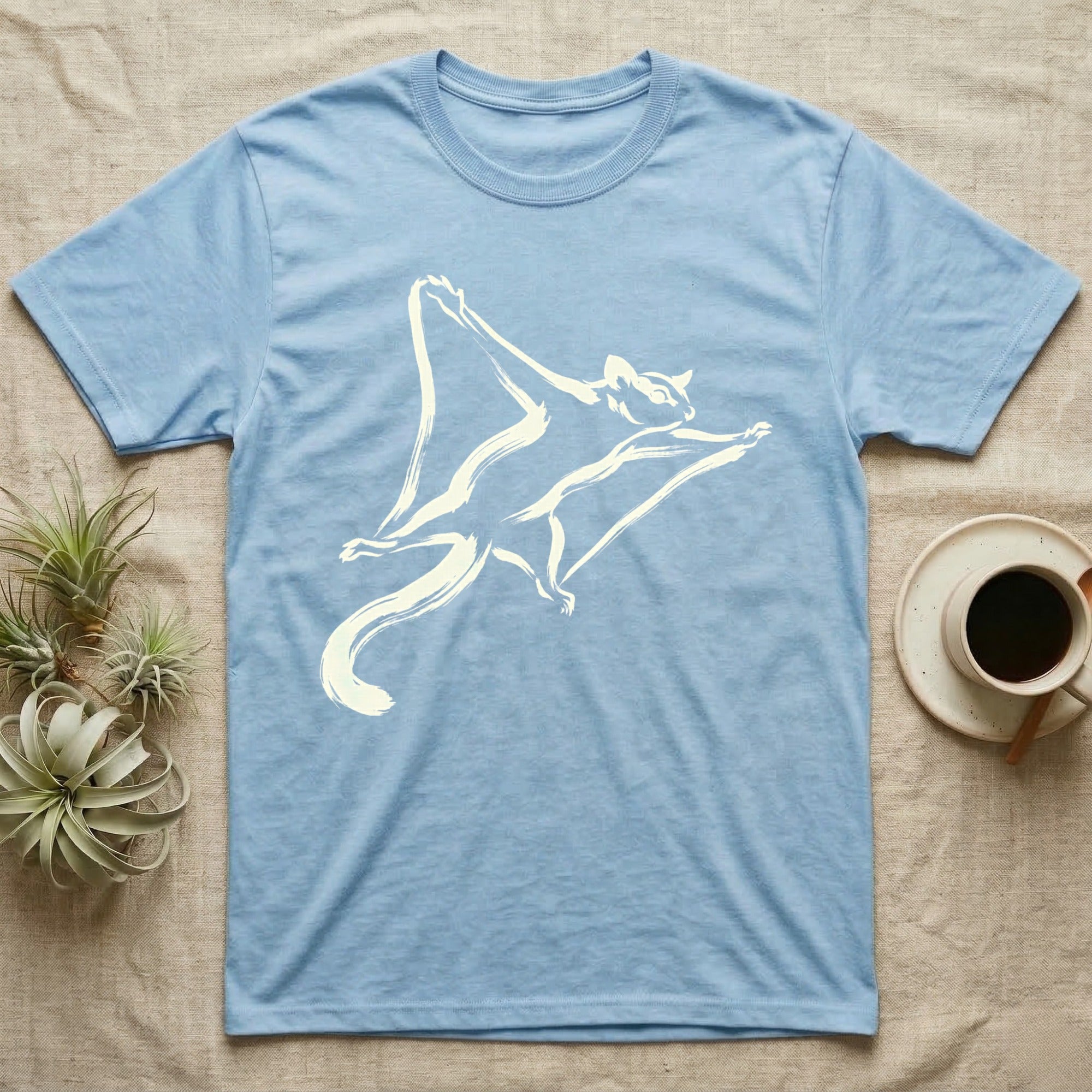 Light blue t-shirt with a white flying squirrel graphic.