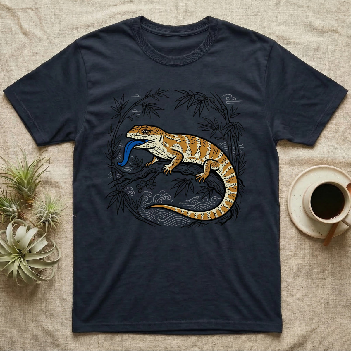 Dark blue t-shirt with orange and yellow bearded dragon illustration on bamboo branch.
