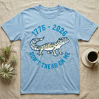 Leopard Gecko 1776 T-Shirt in Light Blue — Two-colour vector leopard gecko in profile ringed by arched text reading 1776 to 2026 and Don't Tread On Me.