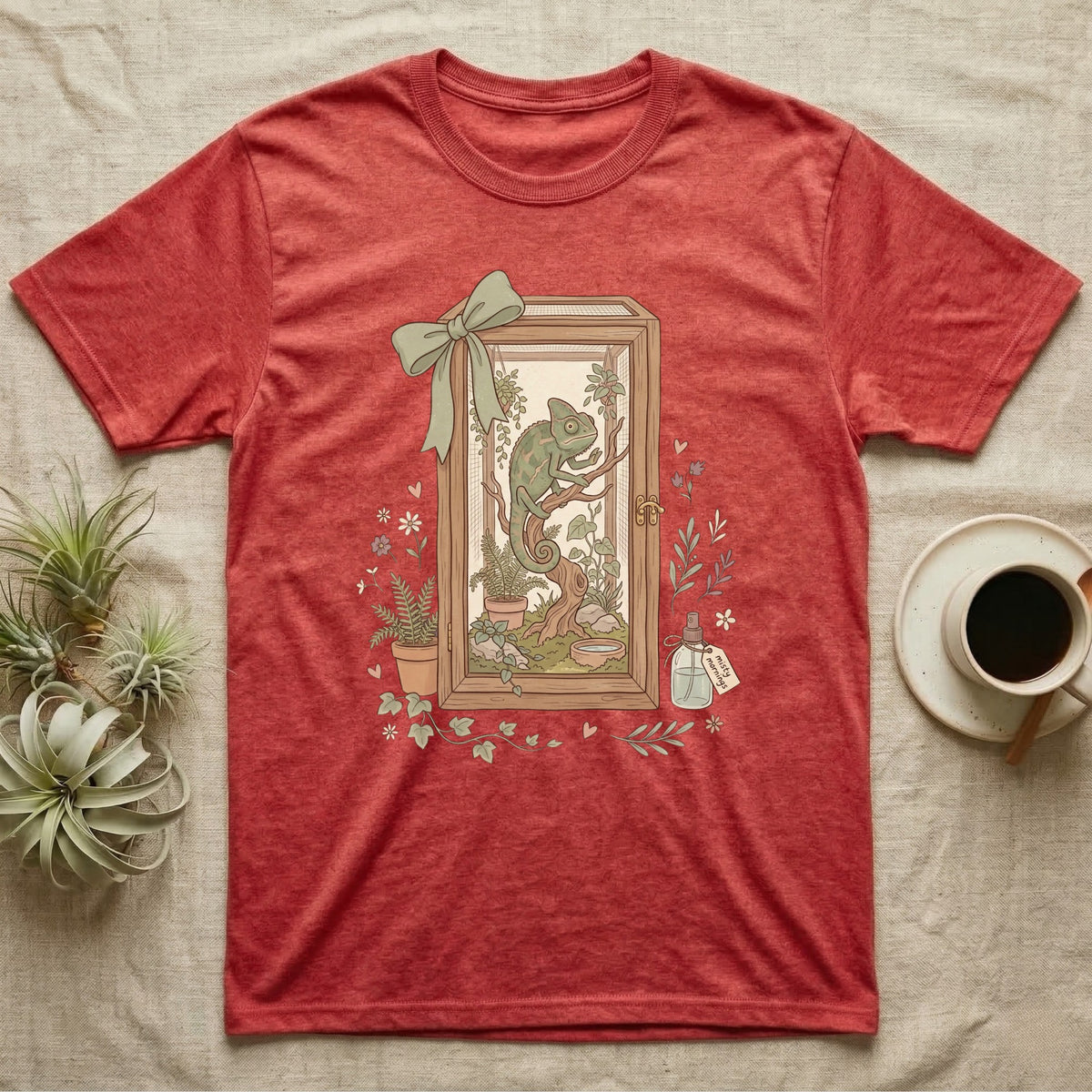Red heathered t-shirt featuring a framed illustration of a chameleon on a branch.