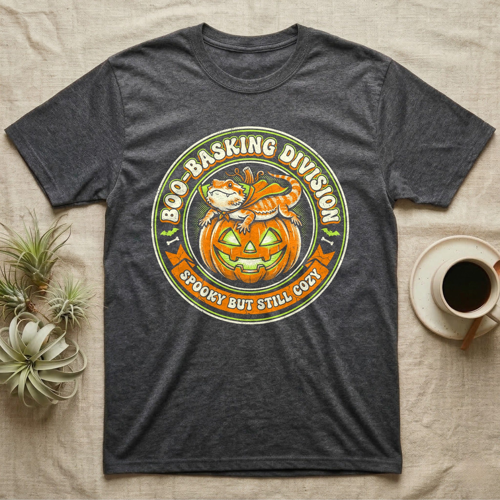 Bearded Dragon Boo-Basking T-Shirt in Dark Heather — Retro badge of a caped bearded dragon on a green-glowing pumpkin, "Boo-Basking Division, Spooky But Still Cozy."