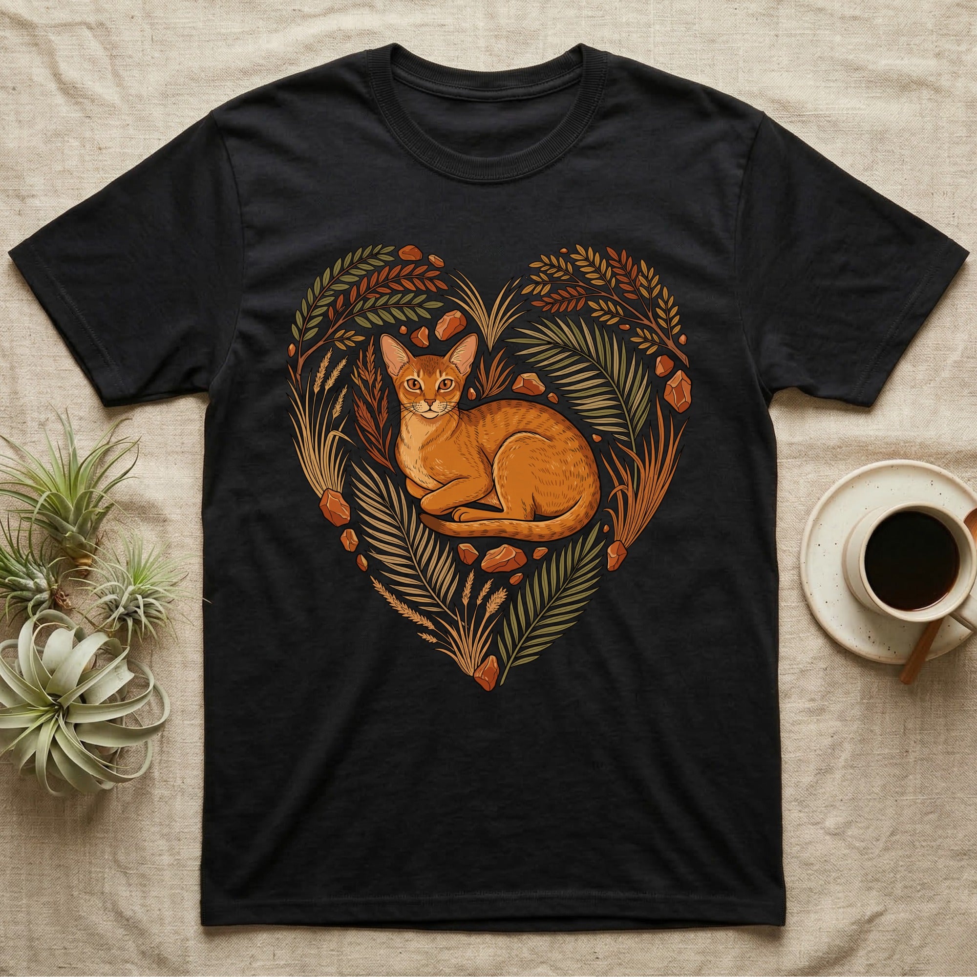 Black t-shirt with heart-shaped botanical design featuring an Abyssinian cat.