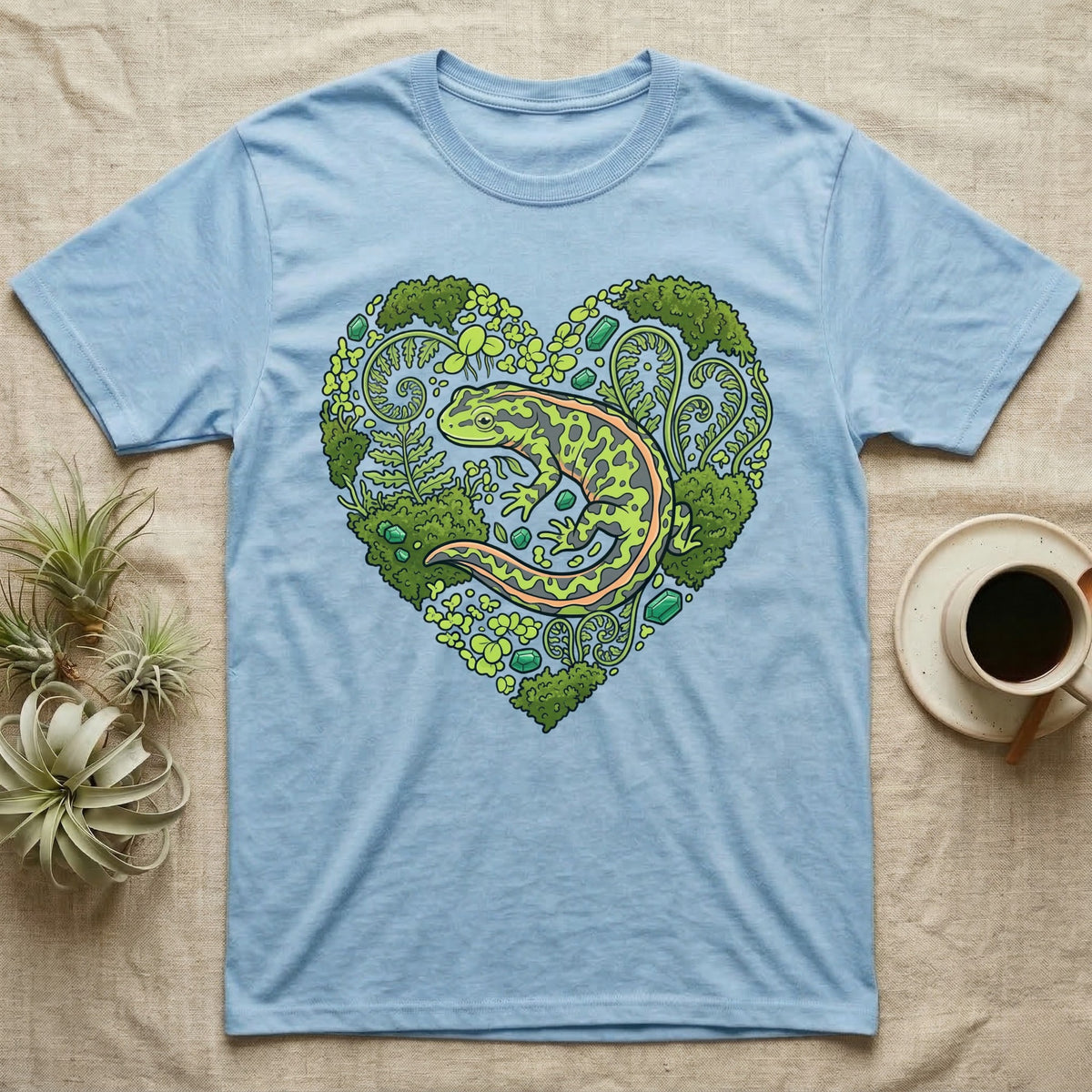 Light blue t-shirt with a heart-shaped forest design featuring a salamander.