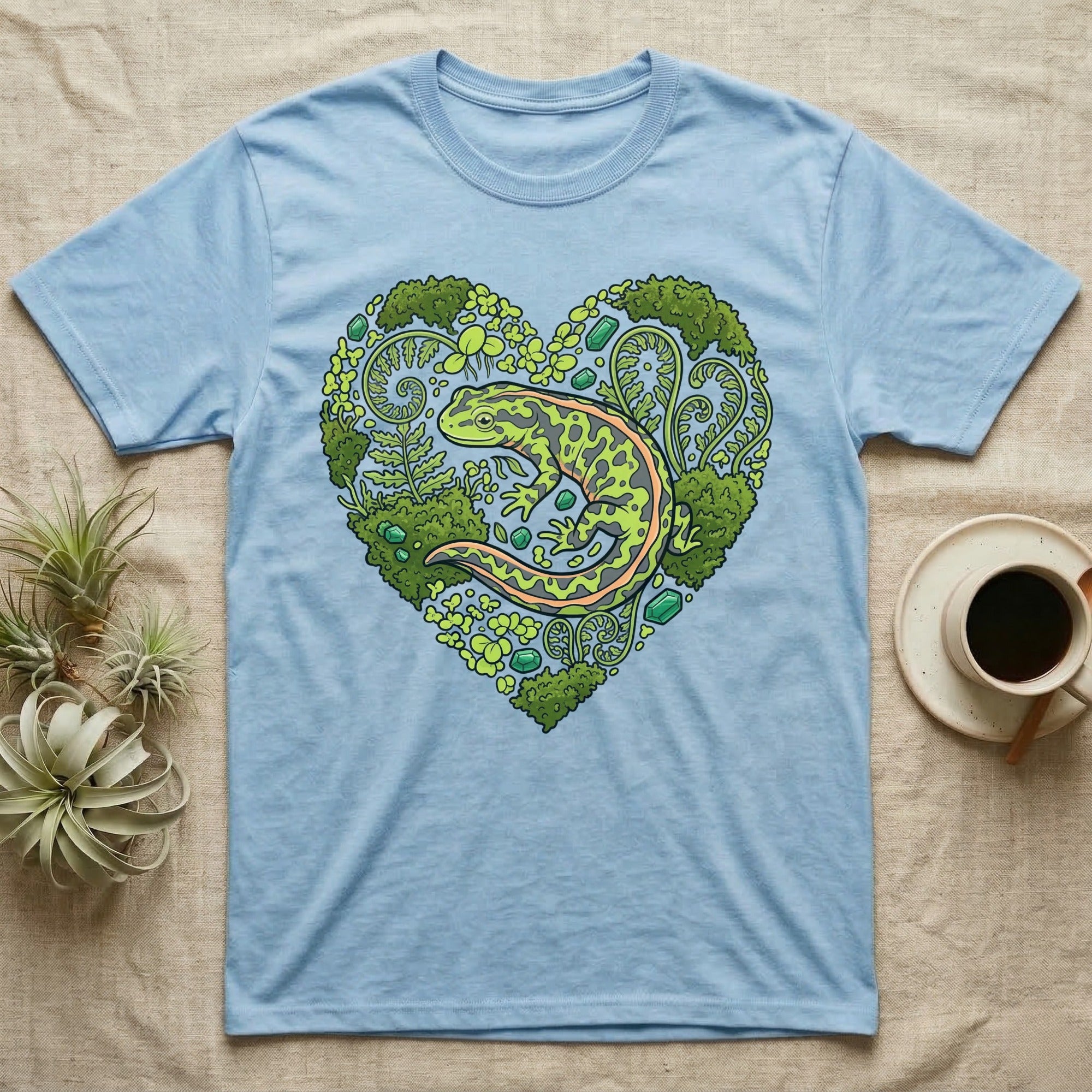 Light blue t-shirt with a heart-shaped forest design featuring a salamander.