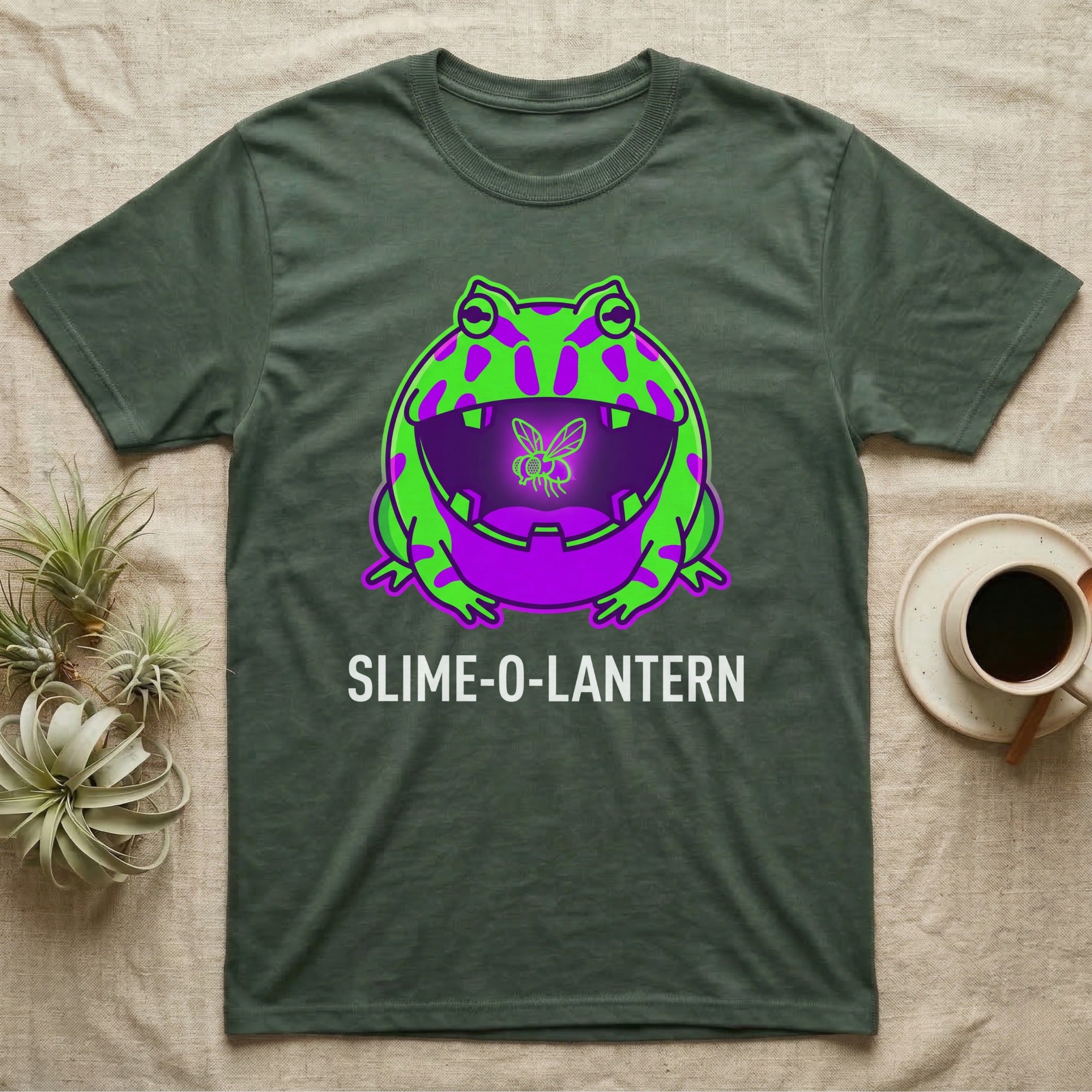 Pacman Frog Slime-O-Lantern T-Shirt in Military Green — Neon pop-art Pacman frog shaped like a jack-o'-lantern with a lit fly in its mouth, "Slime-O-Lantern."