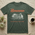 Hermit Crab Homeowner T-Shirt in Military Green — White-line engraving of a land hermit crab eyeing a bigger empty shell, under orange script Homeowner and a serif line