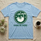 Light blue t-shirt with "HANG IN THERE" and a raccoon hanging from a branch.
