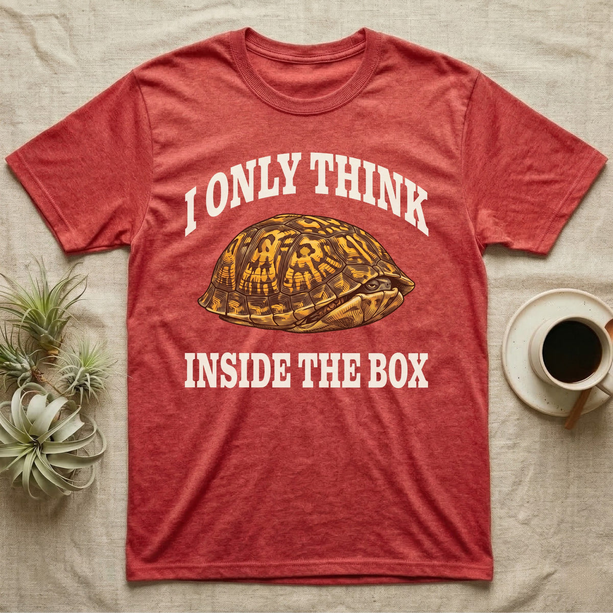Box Turtle Thinker T-Shirt in Heather Red — Engraved eastern box turtle shut in its shell, one eye peeking out, under I Only Think Inside the Box