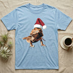 Vintage comic illustration of a bearded dragon wearing a red and white Santa hat, graphic-only, no text. — shown on a Light Blue tee.