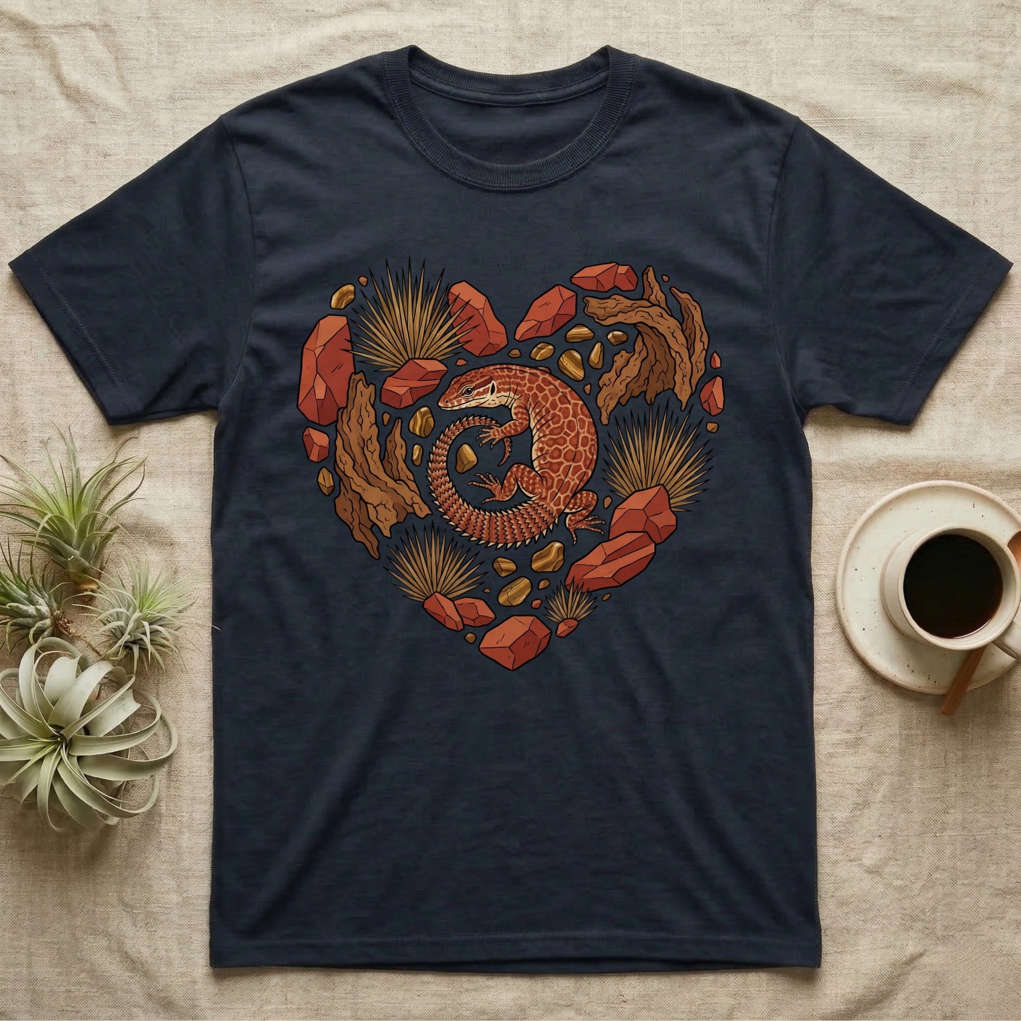 Dark t-shirt with a heart design featuring a lizard and desert stones.