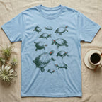 Red-Eared Slider Specimen T-Shirt in Light Blue — One red-eared slider repeated ten times in olive-green screen-print specks, each at a different size and angle, with a small red stripe behind every eye.