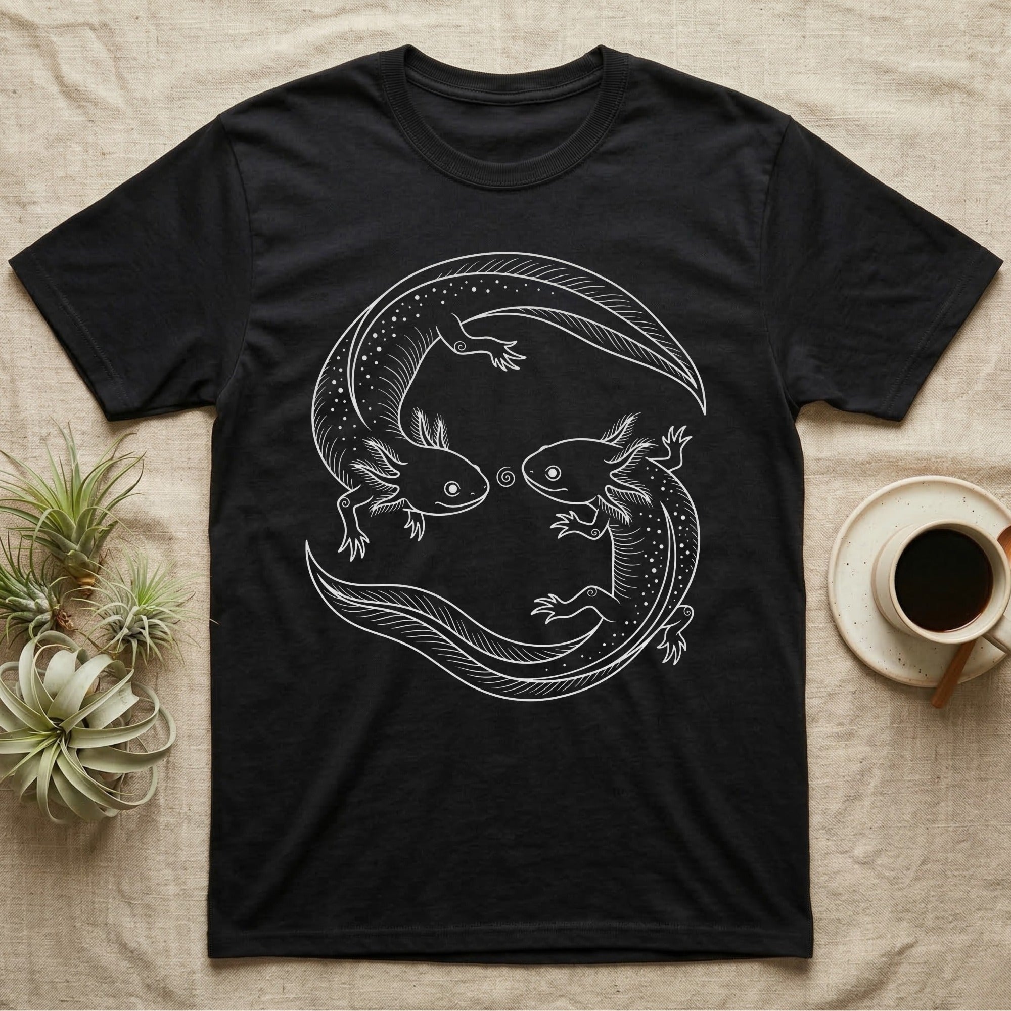 Axolotl Pair Roundel T-Shirt in Black — Fine-line drawing of two axolotls in a rotational roundel, heads meeting over a small spiral on grey