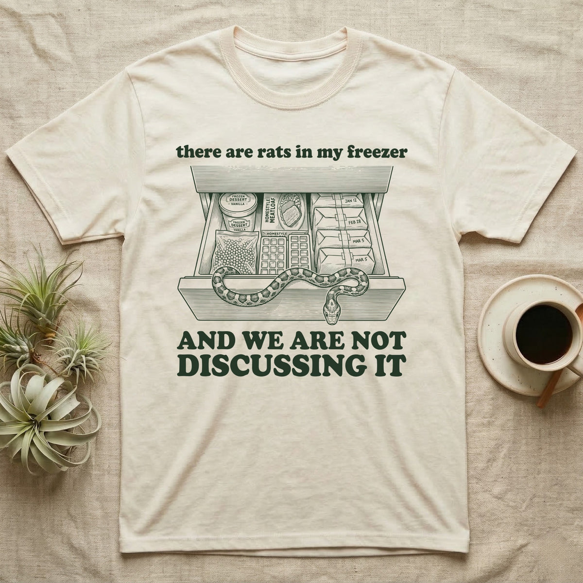 Corn Snake Freezer T-Shirt in Natural — Engraved corn snake draped over an open kitchen freezer drawer of food and dated parcels, between there are rats in my freezer and AND WE ARE NOT DISCUSSING IT.
