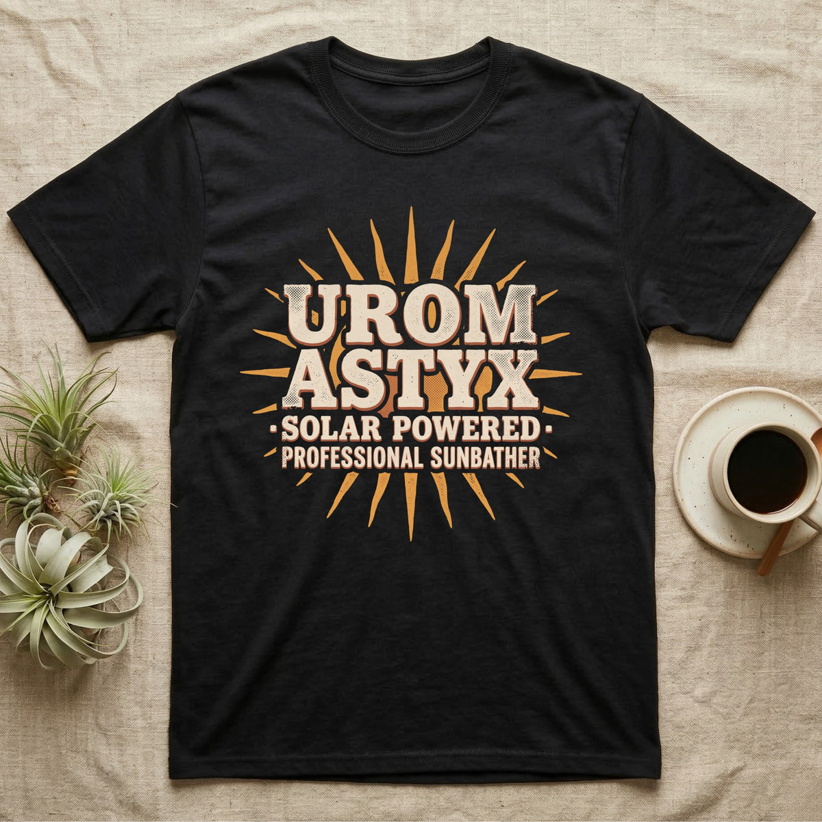 Solar Powered Uromastyx T-Shirt in Black — Desert-poster wordmark reading "Uromastyx Solar Powered Professional Sunbather" with a small radiating sun motif.