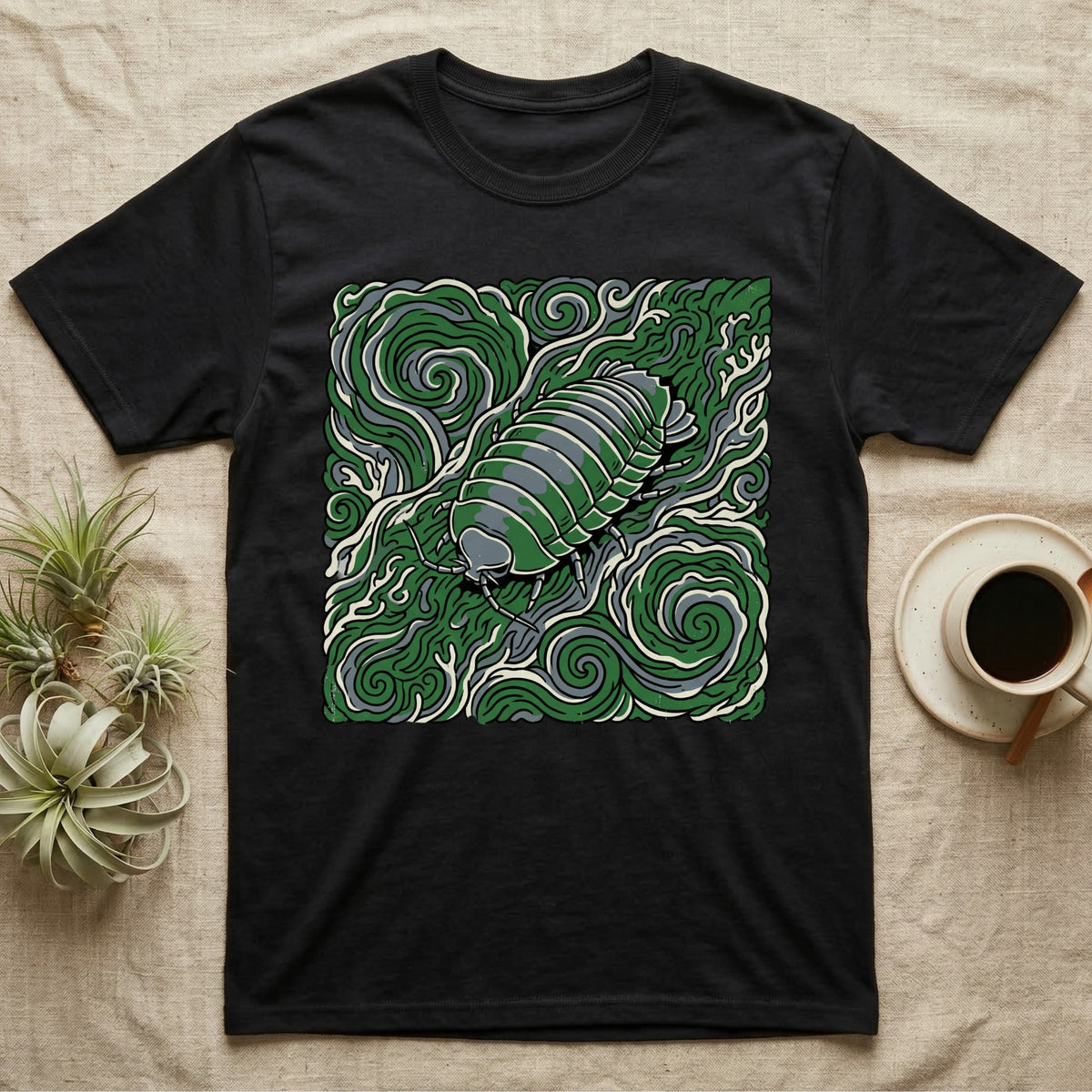 Black t-shirt with a stylized green woodlouse on a swirled green background.