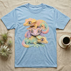 Stack of three pastel geckos on a light blue t-shirt.