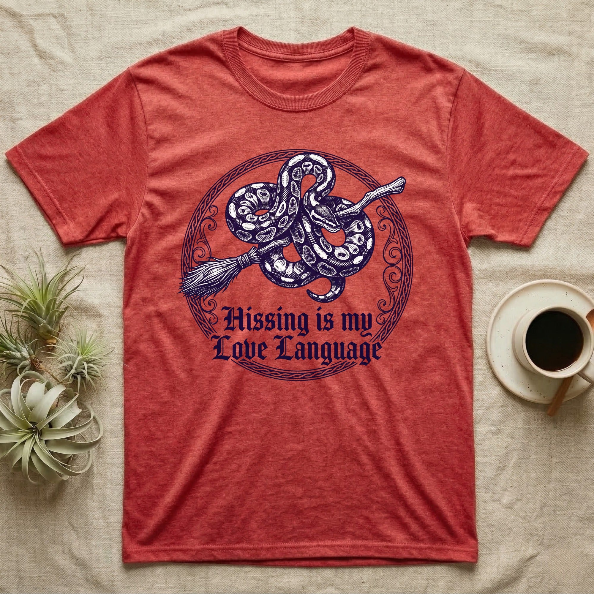 Ball Python Hissing Love Language T-Shirt in Heather Red — Navy engraving of a ball python coiled around a broomstick in a knotwork ring, "Hissing Is My Love Language."