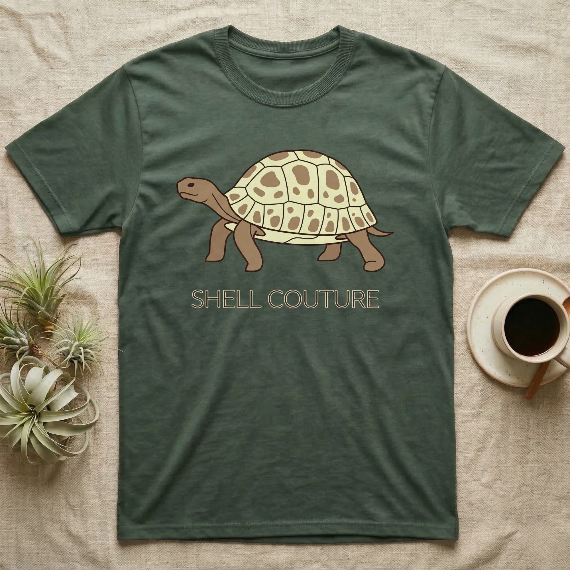 Green t-shirt with cartoon tortoise and "SHELL COUTURE" text.
