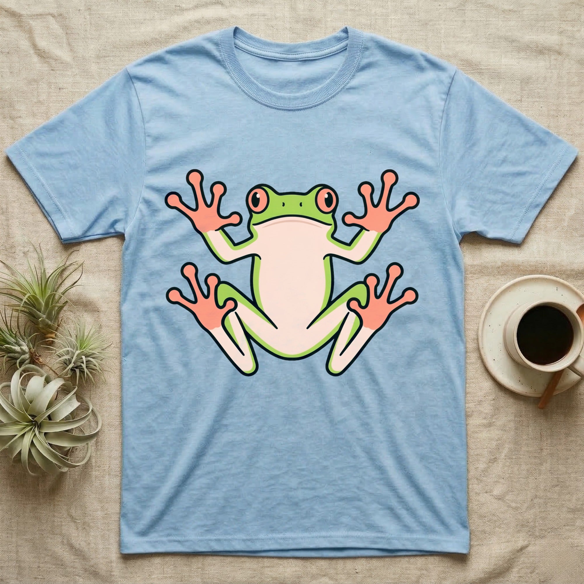 Tree Frog On Glass T-Shirt in Light Blue — Vector-bold tree frog plastered against implied glass, suction feet splayed wide, small "Tree Frog On Glass." caption.