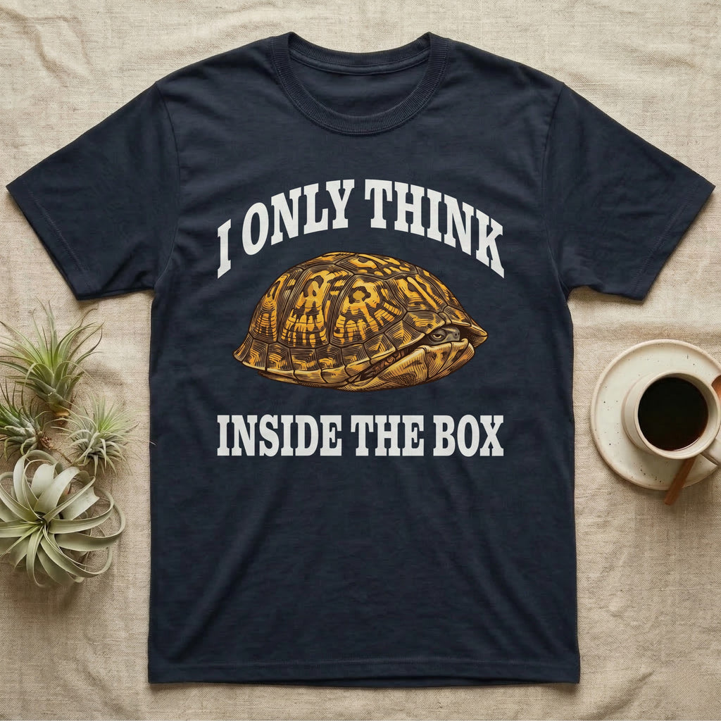 Box Turtle Thinker T-Shirt in Navy — Engraved eastern box turtle shut in its shell, one eye peeking out, under I Only Think Inside the Box