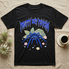Cobalt Blue Tarantula Feral T-Shirt in Black — Cobalt blue tarantula with electric-blue legs under jagged cobalt metal text PRETTY BUT PSYCHO with pastel blossoms
